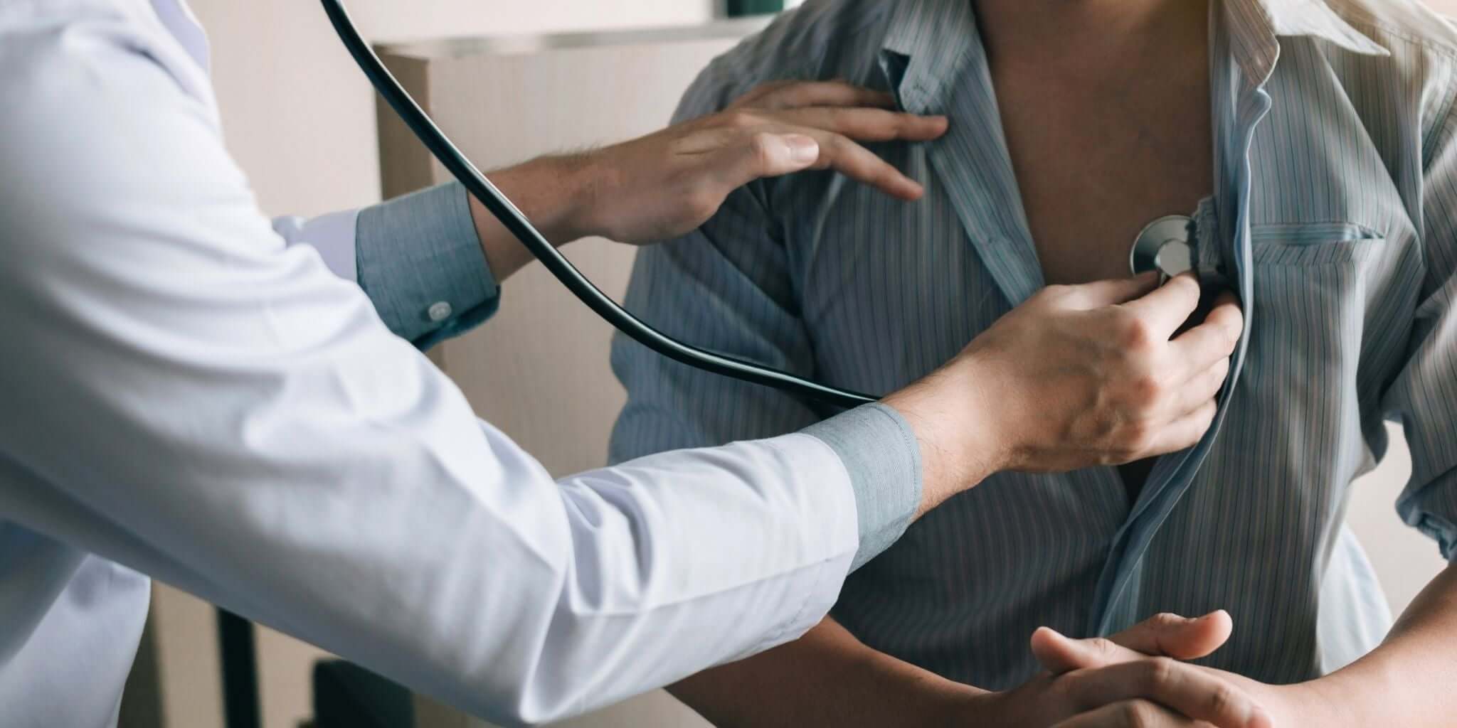 Doctor using a stethoscope to examine a patient's chest, symbolizing cardiovascular health and wellness care.