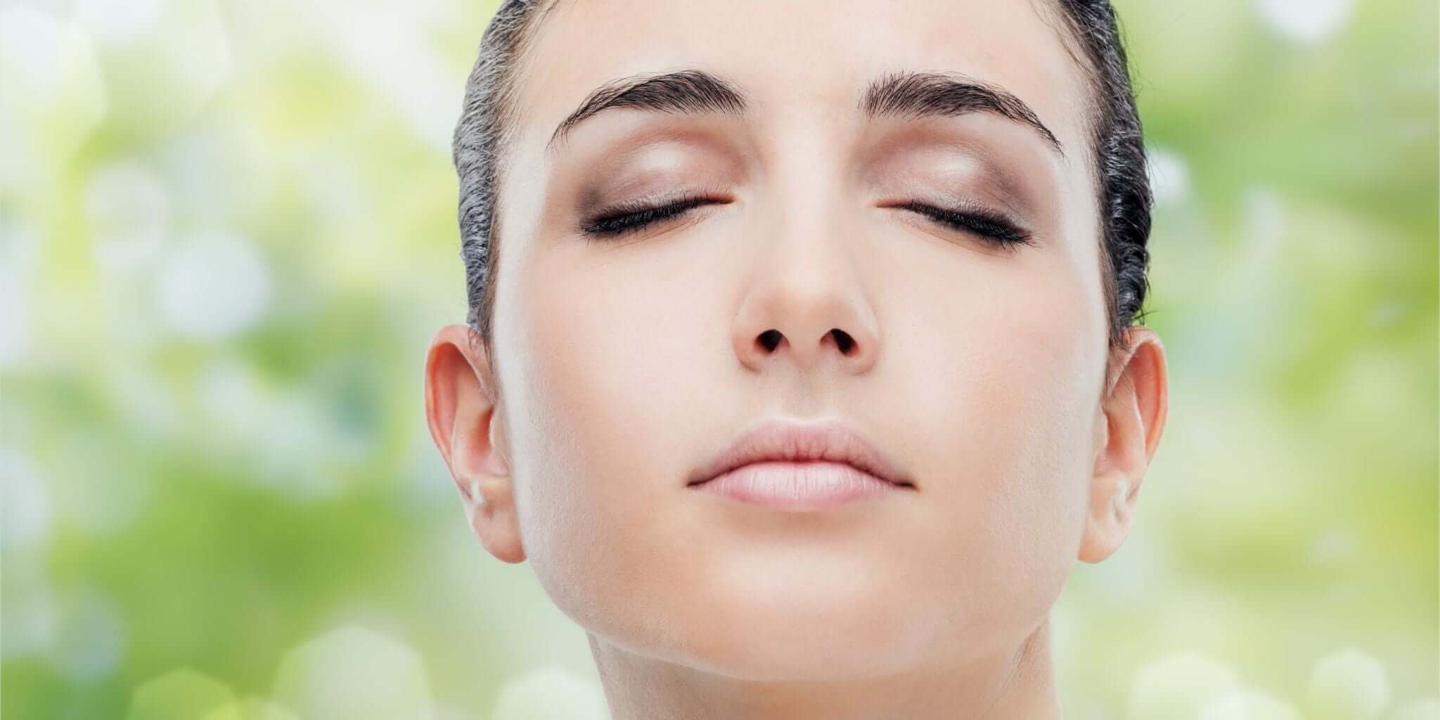 Close-up of a woman's face with closed eyes, showcasing the calming benefits of Sacred Plant Co's detox teas for achieving naturally radiant and clear skin.