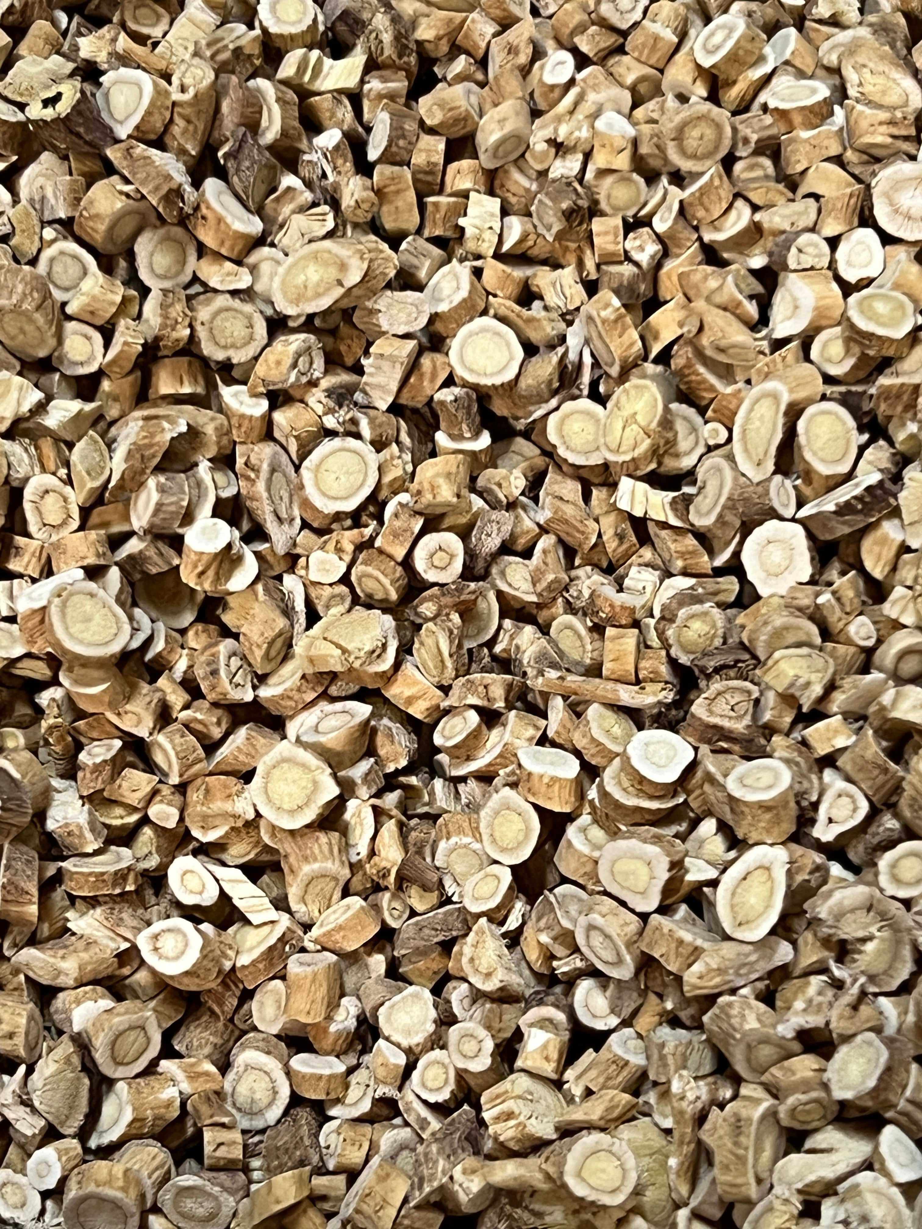 Close-up of sliced batch of Astragalus Root, highlighting its natural wood-like texture and premium quality from Sacred Plant Co.