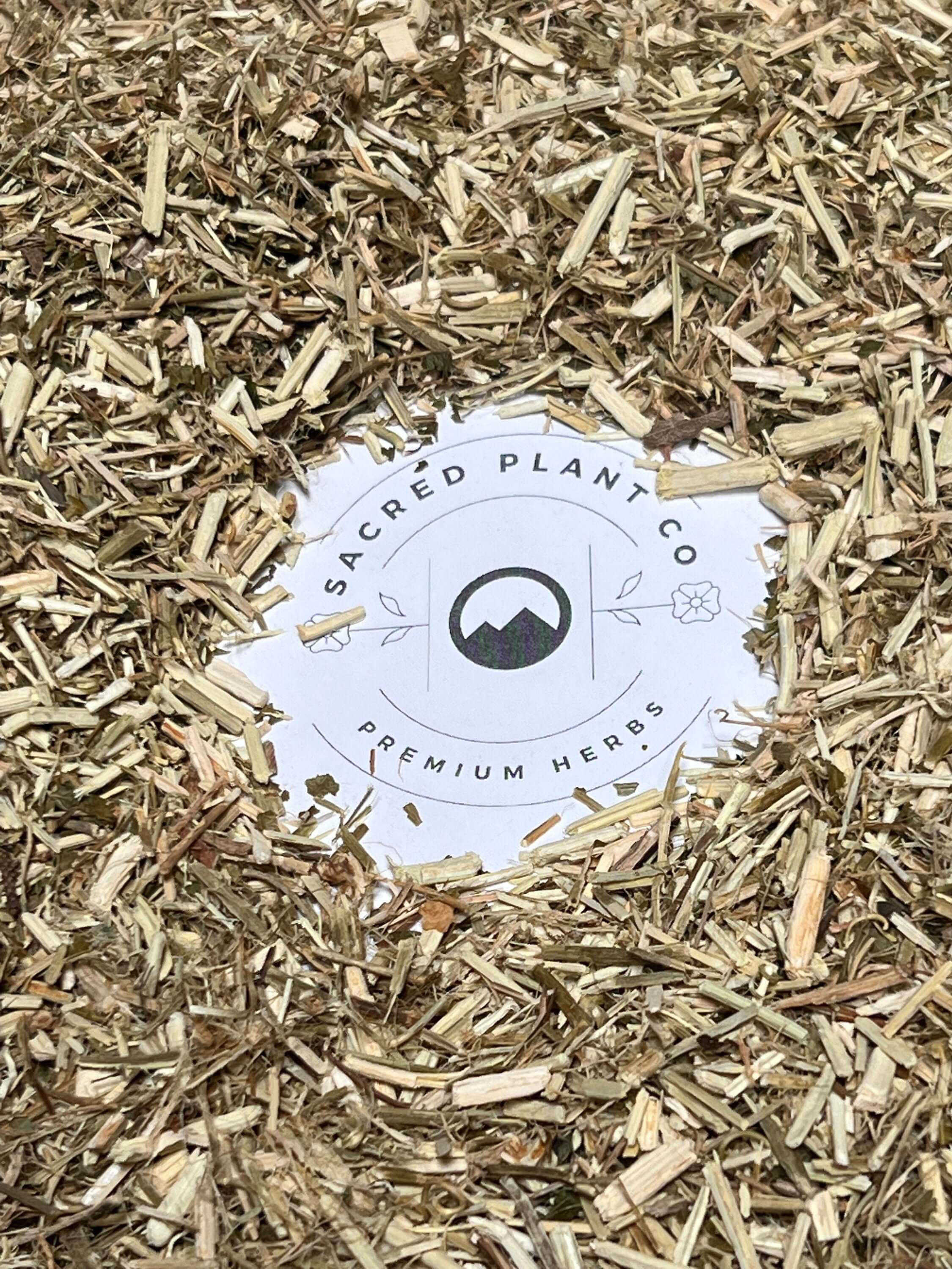 Close-up of premium dried Passion Flower herb from Sacred Plant Co, showcasing its finely cut green and beige texture. Sustainably cultivated with low-water regenerative farming. Ideal for teas, tinctures, and herbal wellness blends.