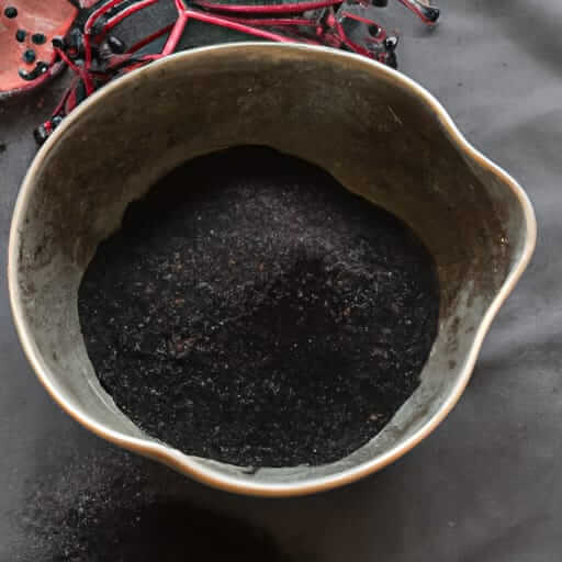 Sacred Plant Co Elderberry Powder in a bowl, featuring a premium quality, smooth dark texture, and rich purple-black color in a flat dark surface.