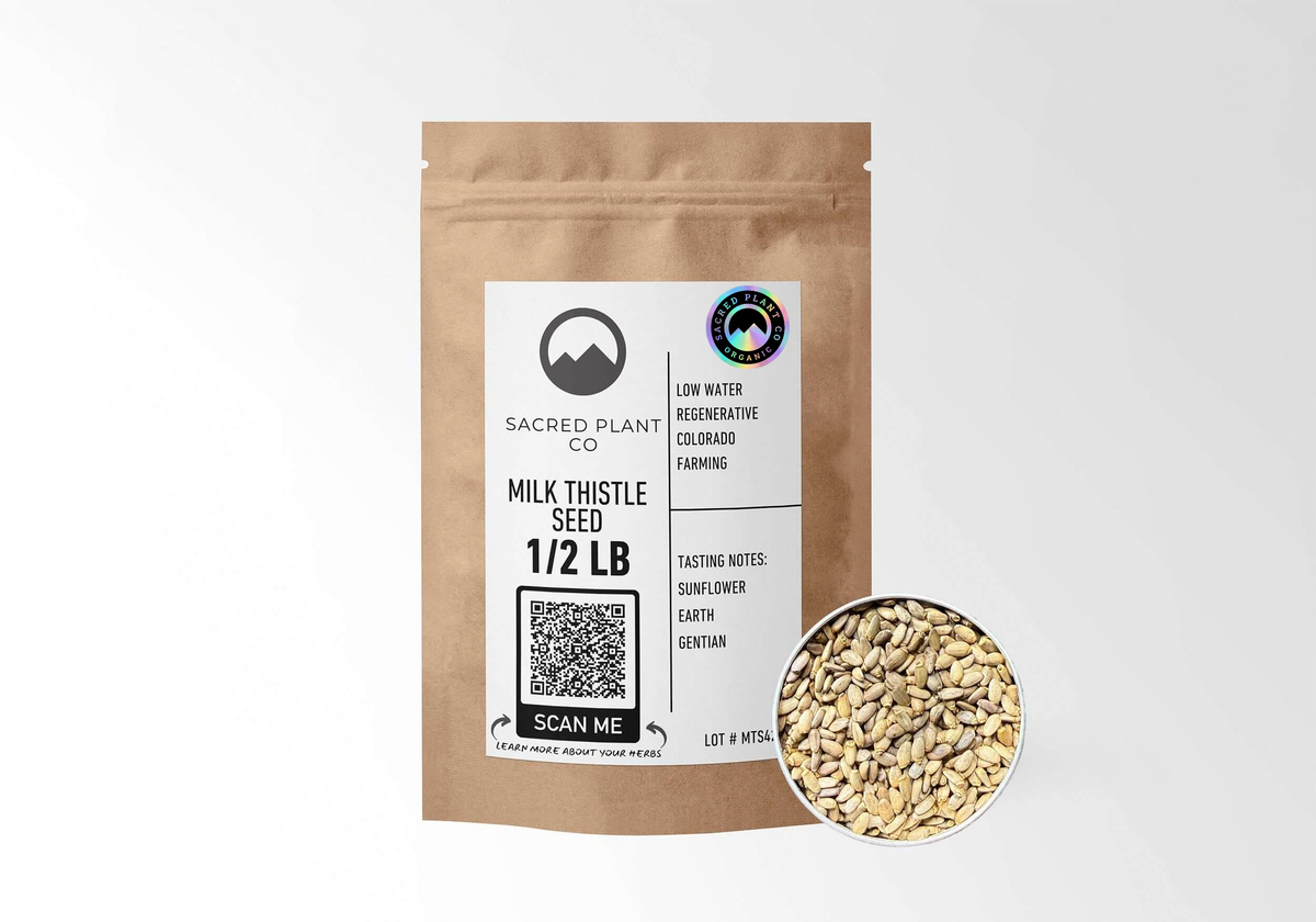 Sacred Plant Co organic milk thistle seed in a 1/2 lb kraft bag with an organic seal, beside an open tin of whole Silybum marianum seeds