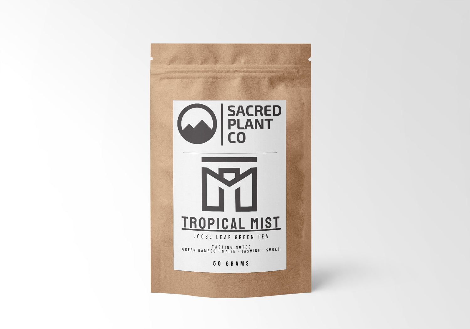 A 50-gram package of Sacred Plant Co Tropical Mist loose leaf green tea, featuring tasting notes of green bamboo, maize, jasmine, and smoke