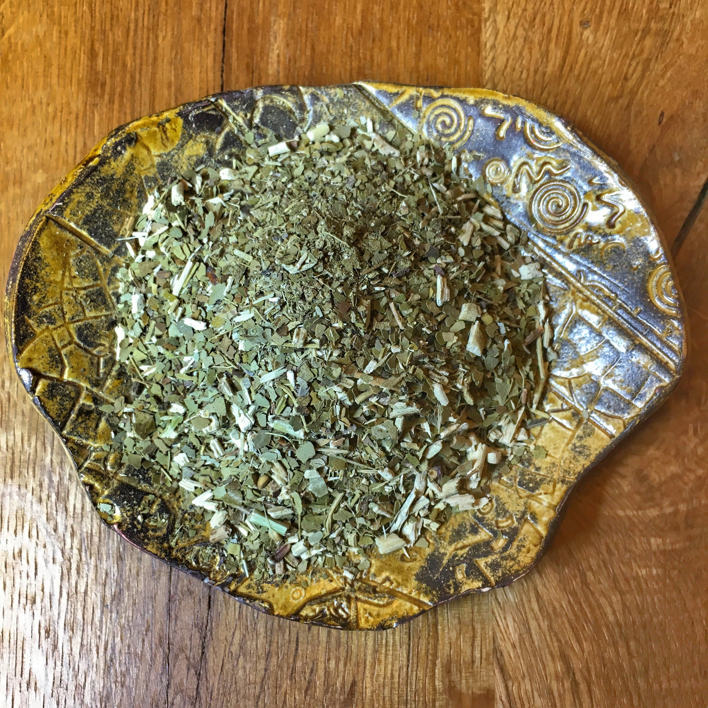 Yerba Santa Mate from Sacred Plant Co displayed on a rustic plate, highlighting the natural quality and texture of the herb on a wooden background.