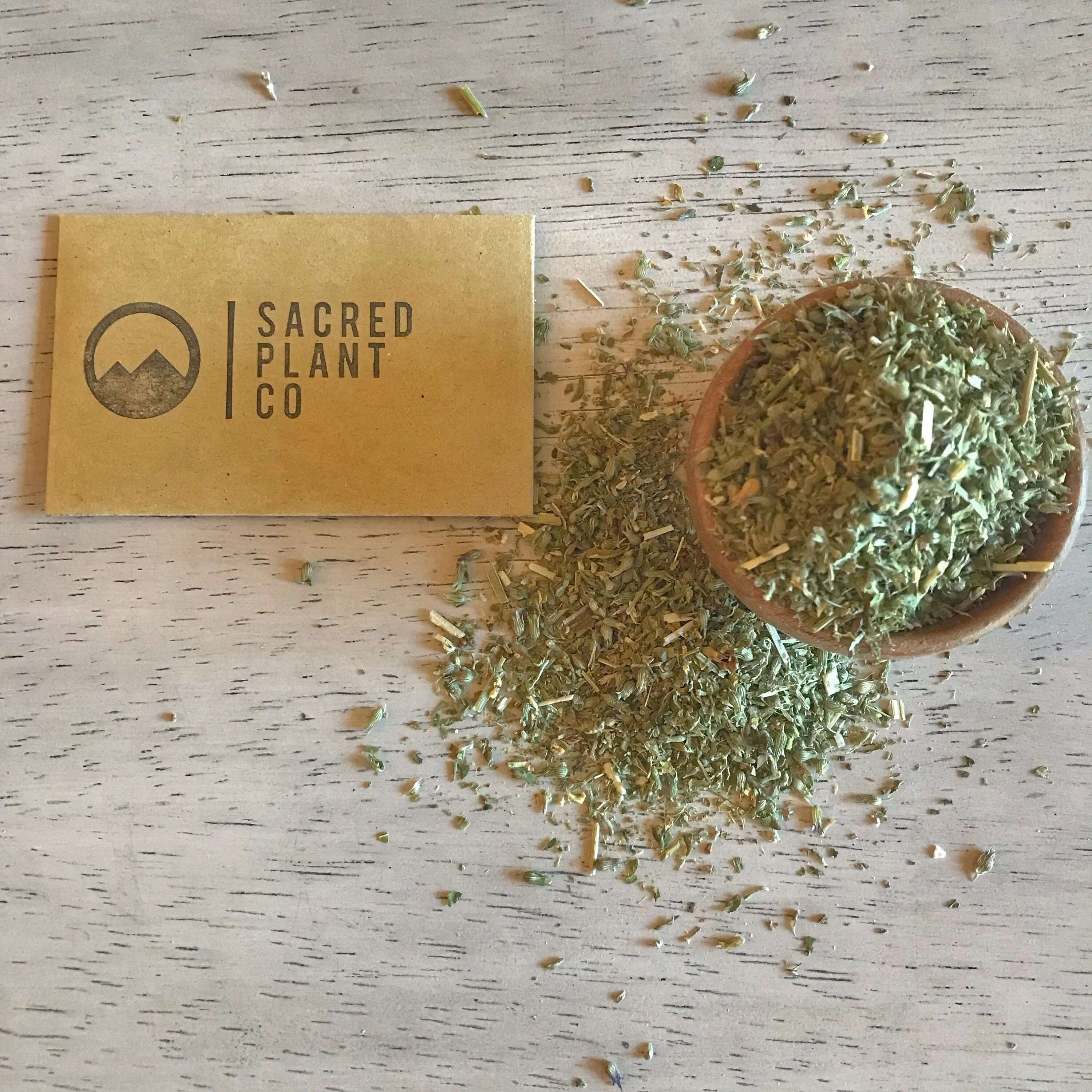 Organic Catnip Herb scattered on a rustic table next to Sacred Plant Co&