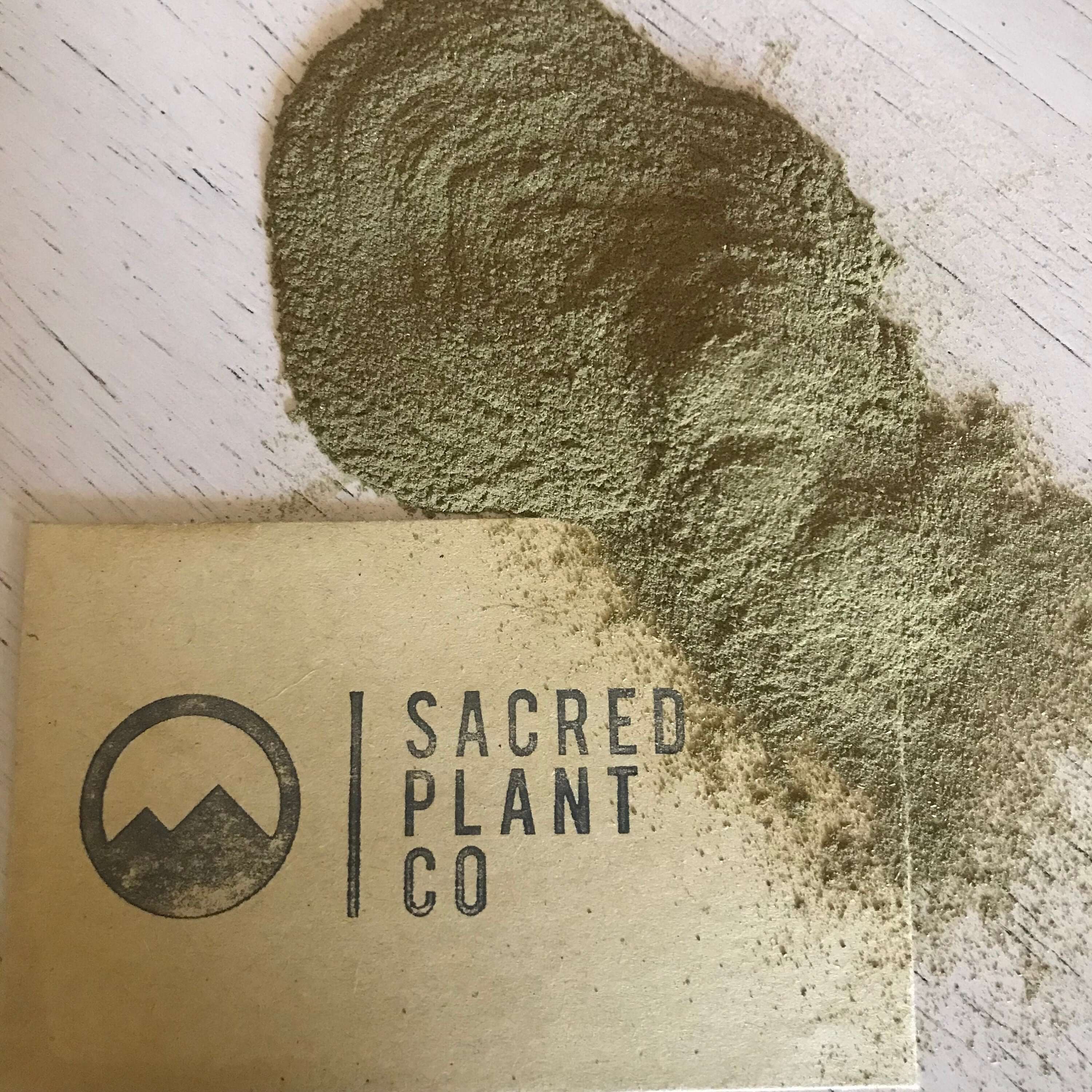 Sacred Plant Co Neem Leaf Powder, with fine, natural green texture spread over a light background, emphasizing its premium quality.