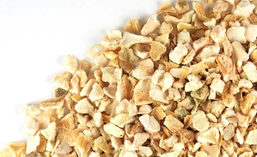 High-quality Sacred Plant Co dried Lemon Peel, displayed up close with a focus on its textured chunks and bright natural colors on a white backdrop.