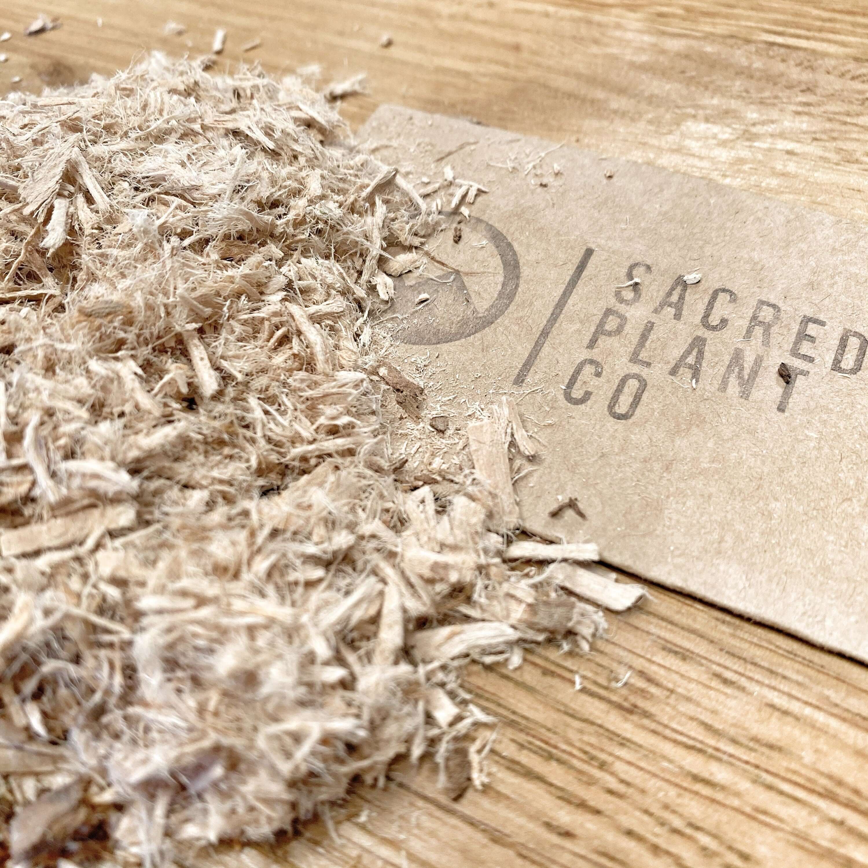 Sacred Plant Co Slippery Elm Bark, finely shredded, showing premium quality with natural beige tones on a wood surface.