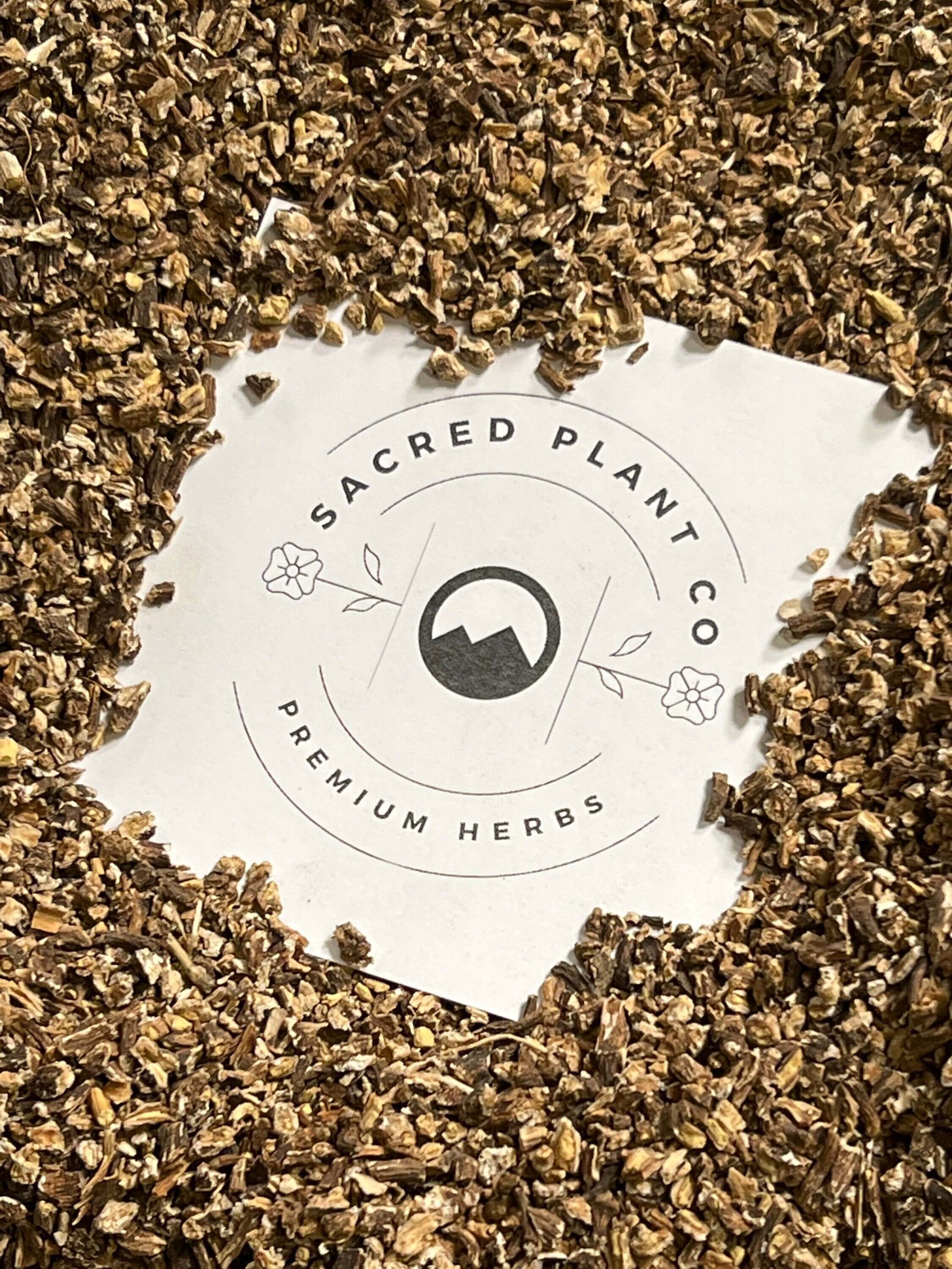 Premium dried Dandelion Root encircling Sacred Plant Co logo, emphasizing superior quality natural herbs.