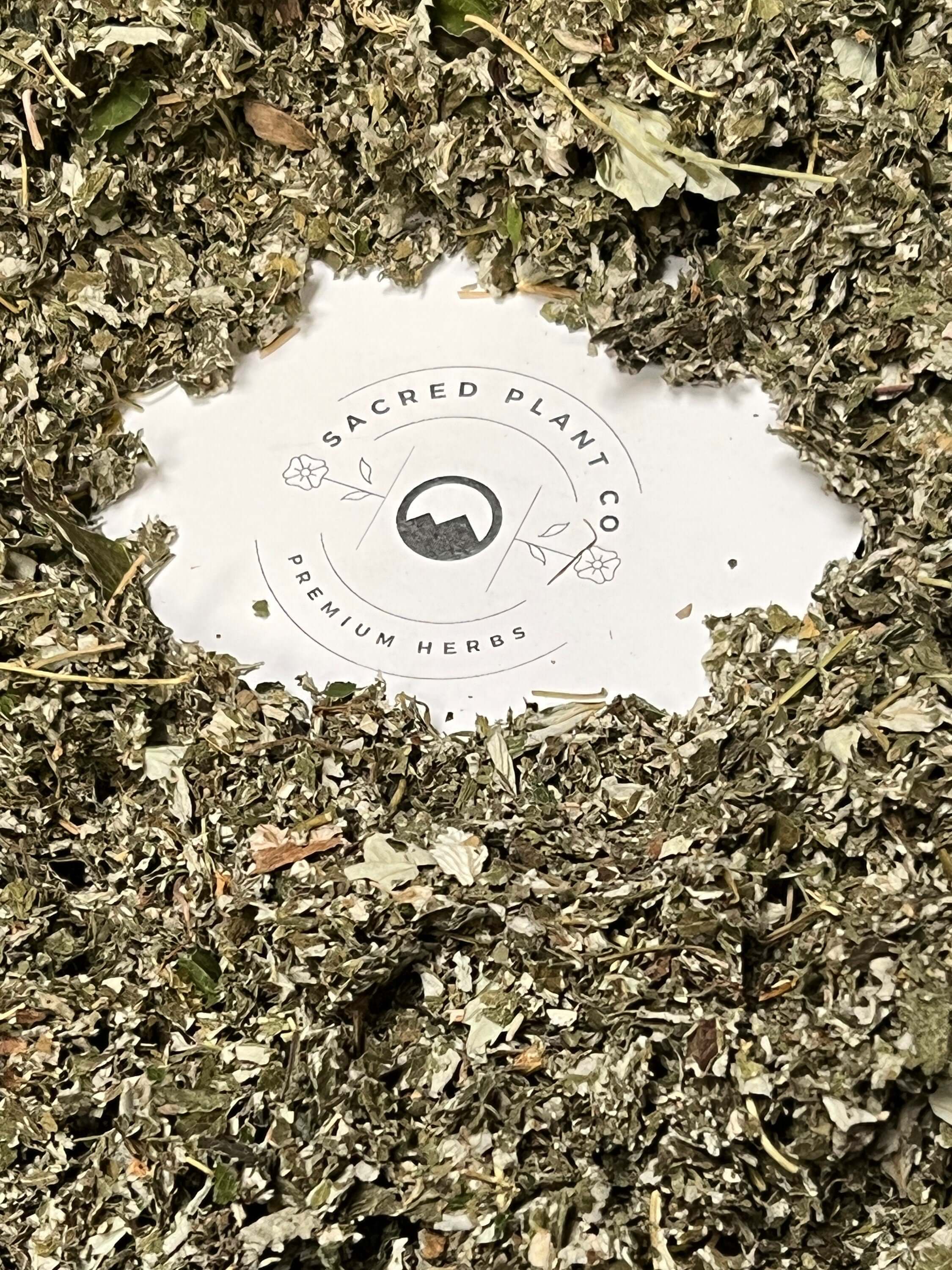 Dried Raspberry Leaf surrounds the Sacred Plant Co logo, emphasizing the premium quality of their natural herbs.
