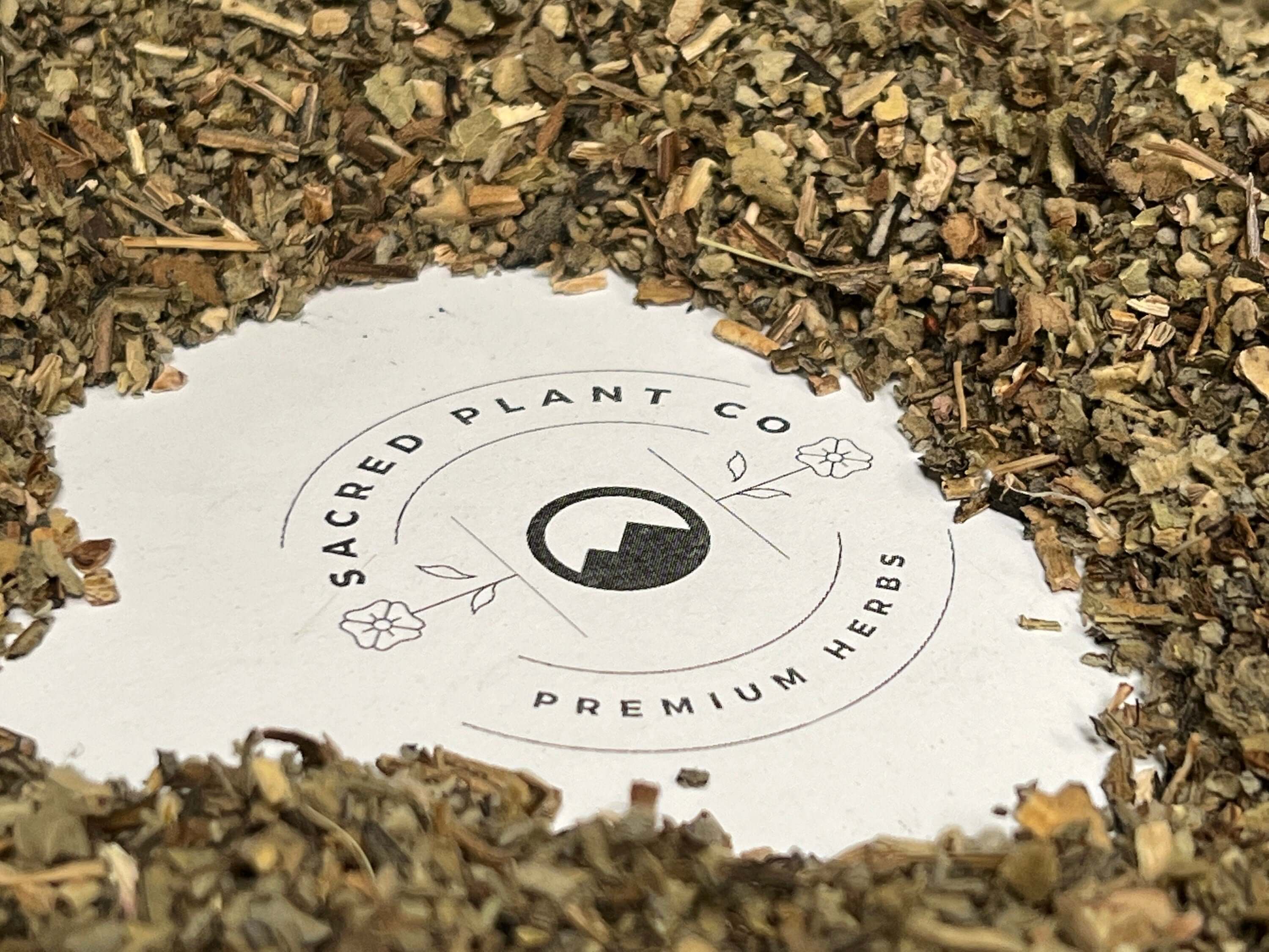 Coarse-textured Mullein Leaf herbs arranged around Sacred Plant Co’s logo, highlighting the brand’s high-quality, organic products.