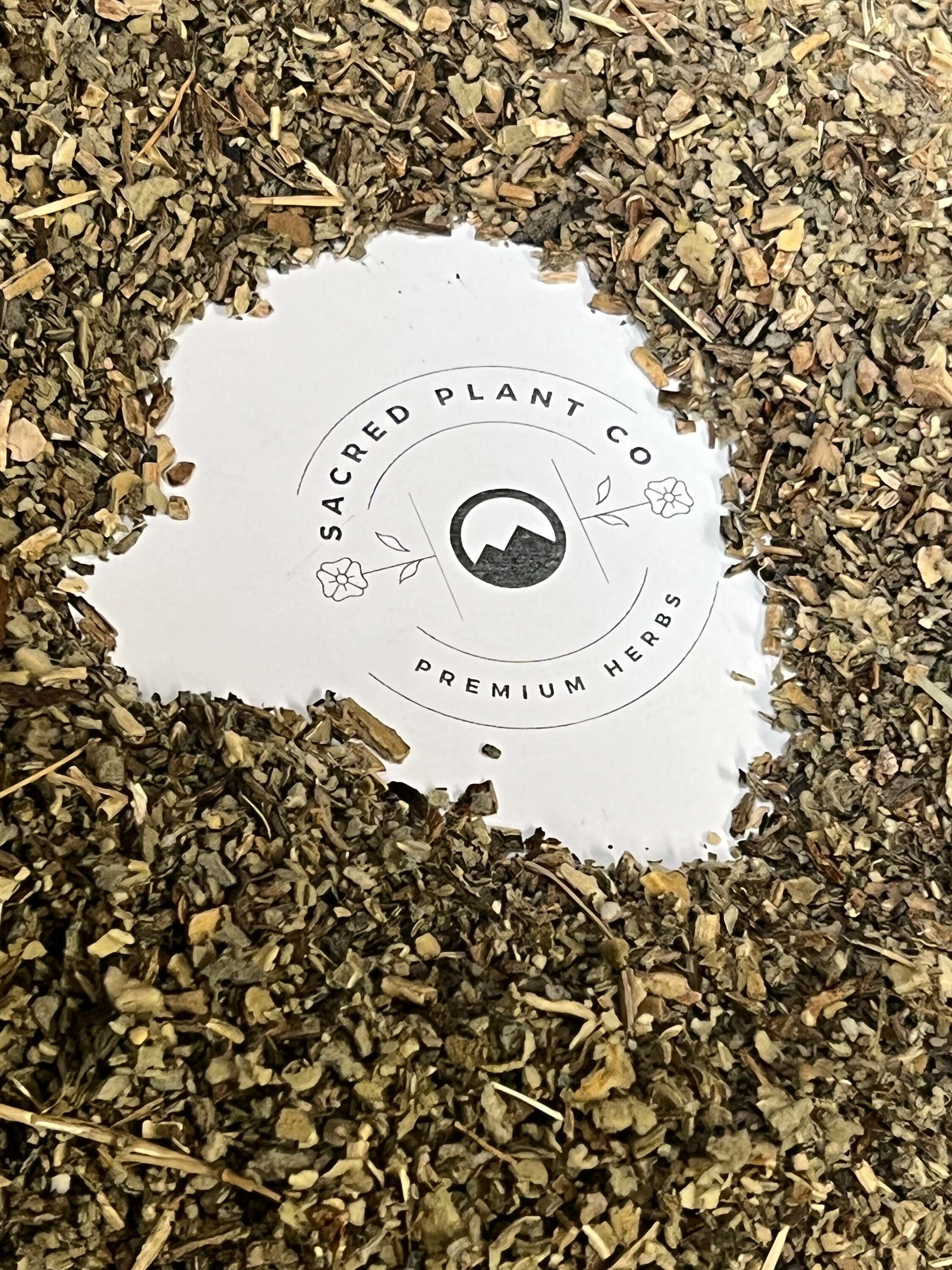 Loose, dried Mullein Leaf in shades of green and brown, encircling Sacred Plant Co logo, emphasizing natural and premium herbs.