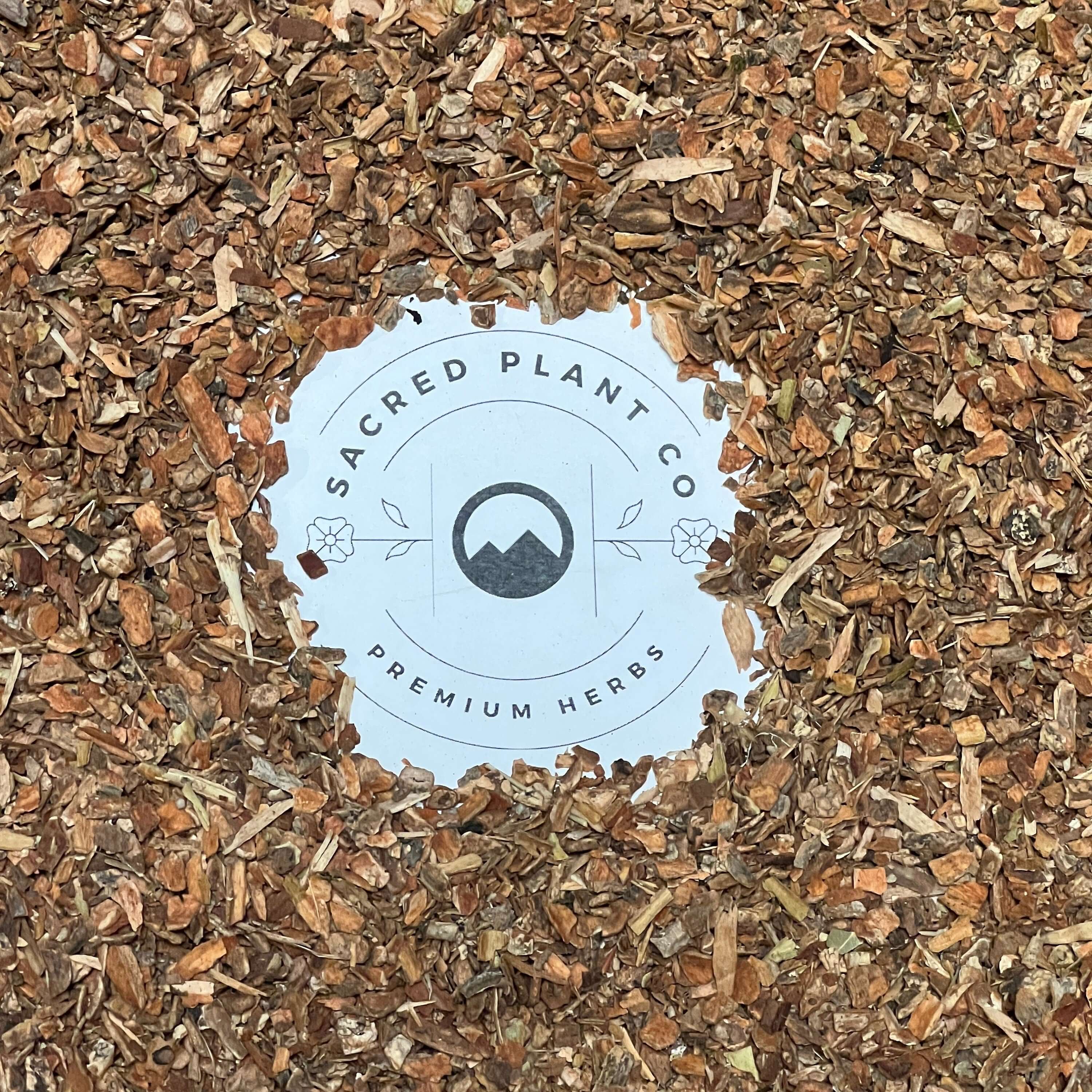 Premium Cramp Bark with rich, earthy hues surrounding Sacred Plant Co’s label, showcasing organic quality and texture.