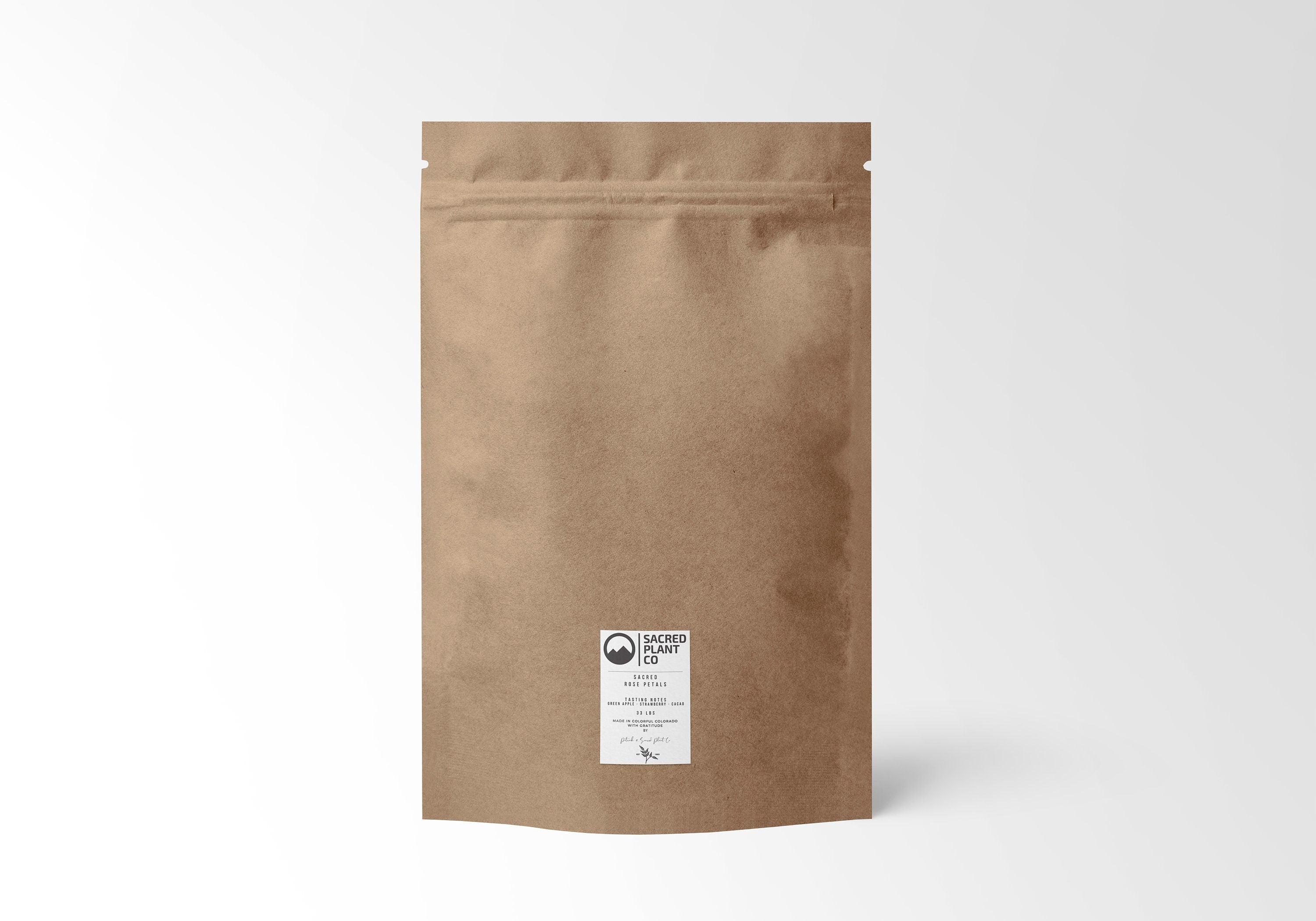 simple, earth-toned kraft pouch from Sacred Plant Co, containing high-quality dried rose petals, with a focus on sustainability.