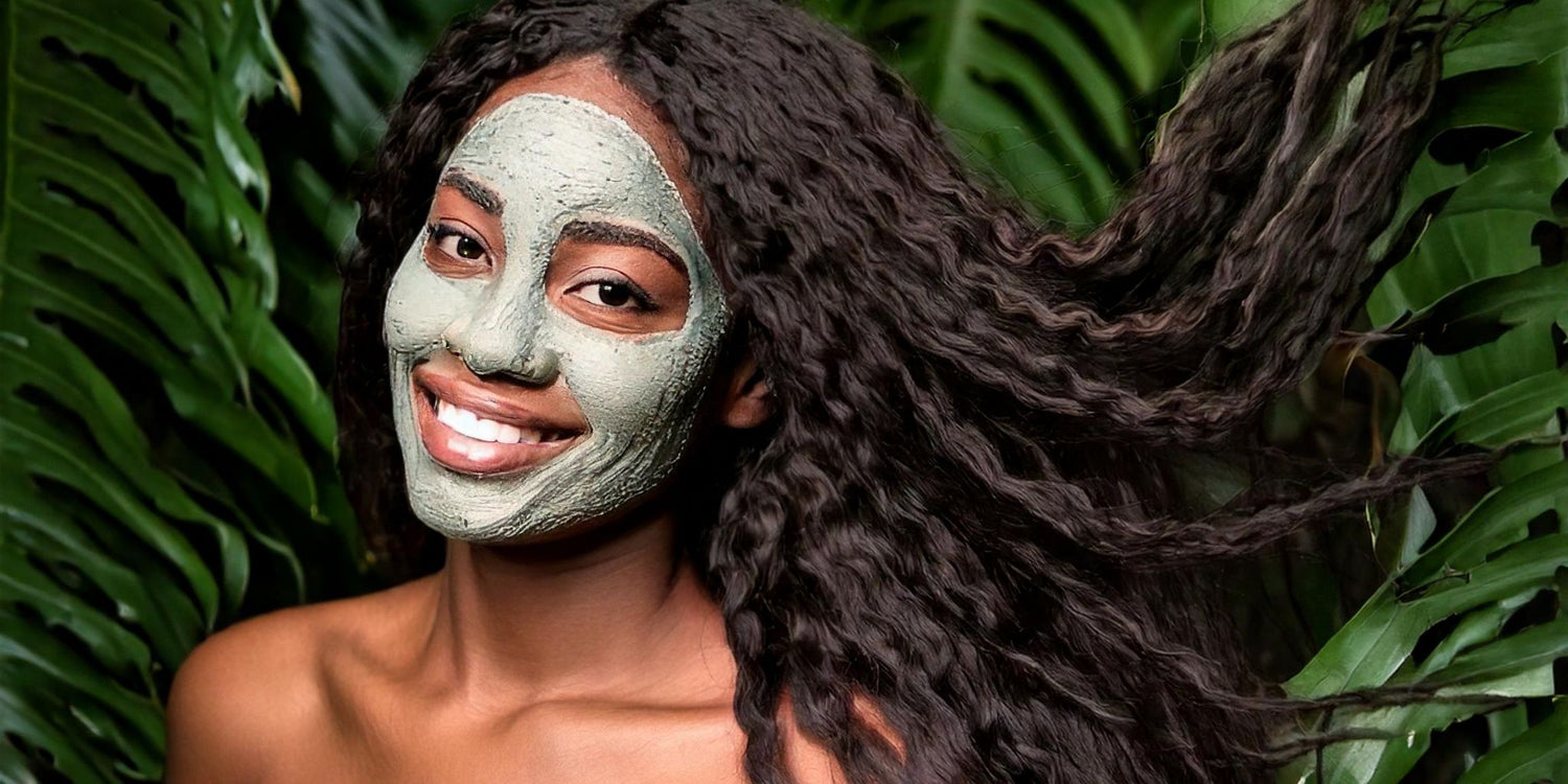 This stunning image showcases a woman with glowing skin wearing a green herbal mask, radiating natural beauty amidst a lush backdrop of tropical leaves, symbolizing the power of herbs for skin health and vitality.