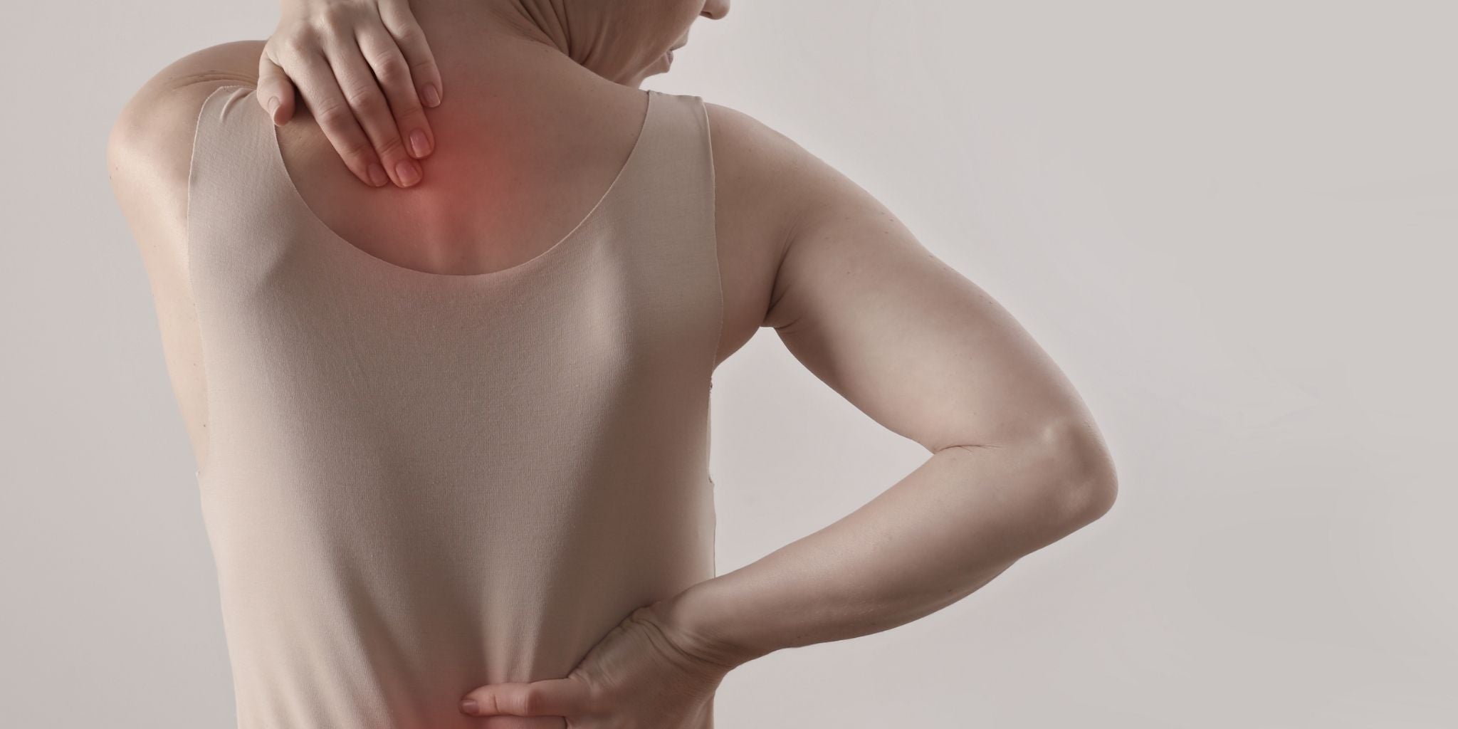 Close-up of a woman touching her neck and back, indicating pain relief and natural solutions for inflammation through Sacred Plant Co’s herbal remedies.