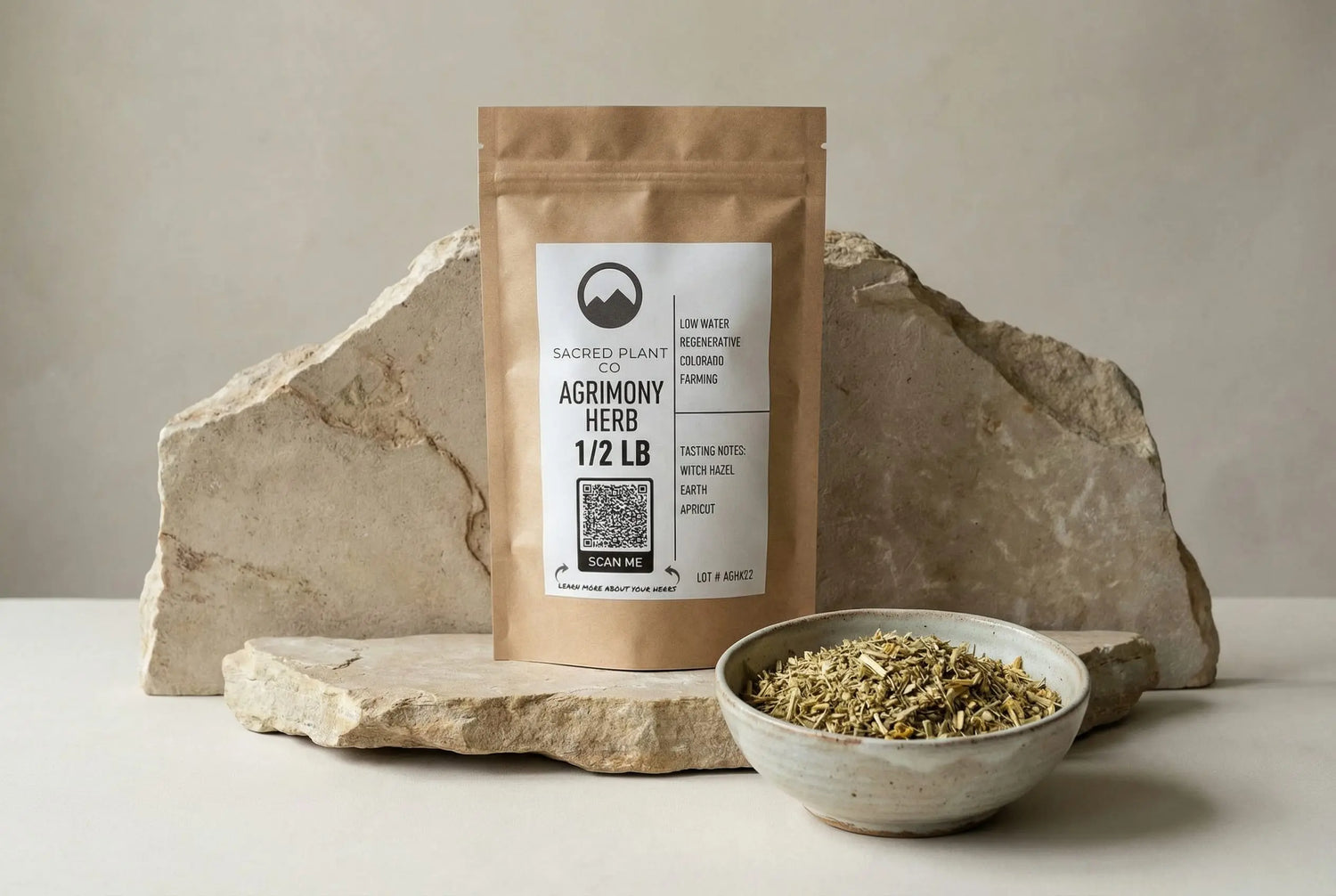 Agrimony herb in Sacred Plant Co apothecary bag on stone, premium botanical still life