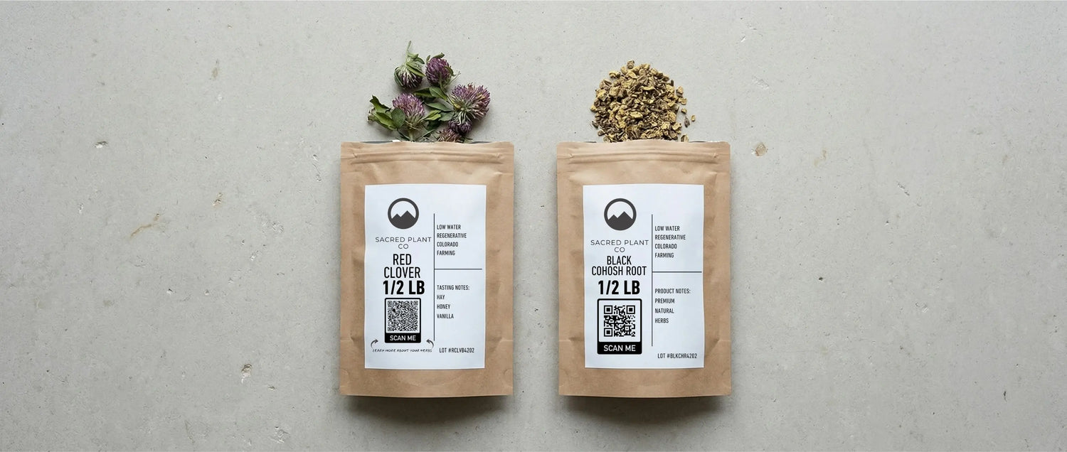 Sacred Plant Co bags of red clover blossoms and black cohosh root side-by-side, comparing menopause support herbs.