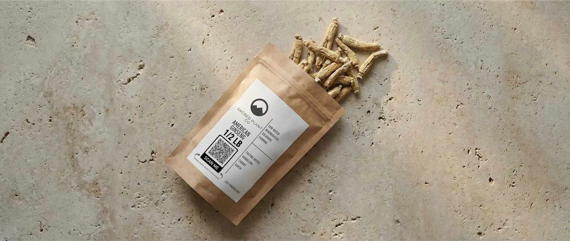 Dried American Ginseng roots spilling from a Sacred Plant Co kraft paper pouch featuring a QR code for lab test transparency.