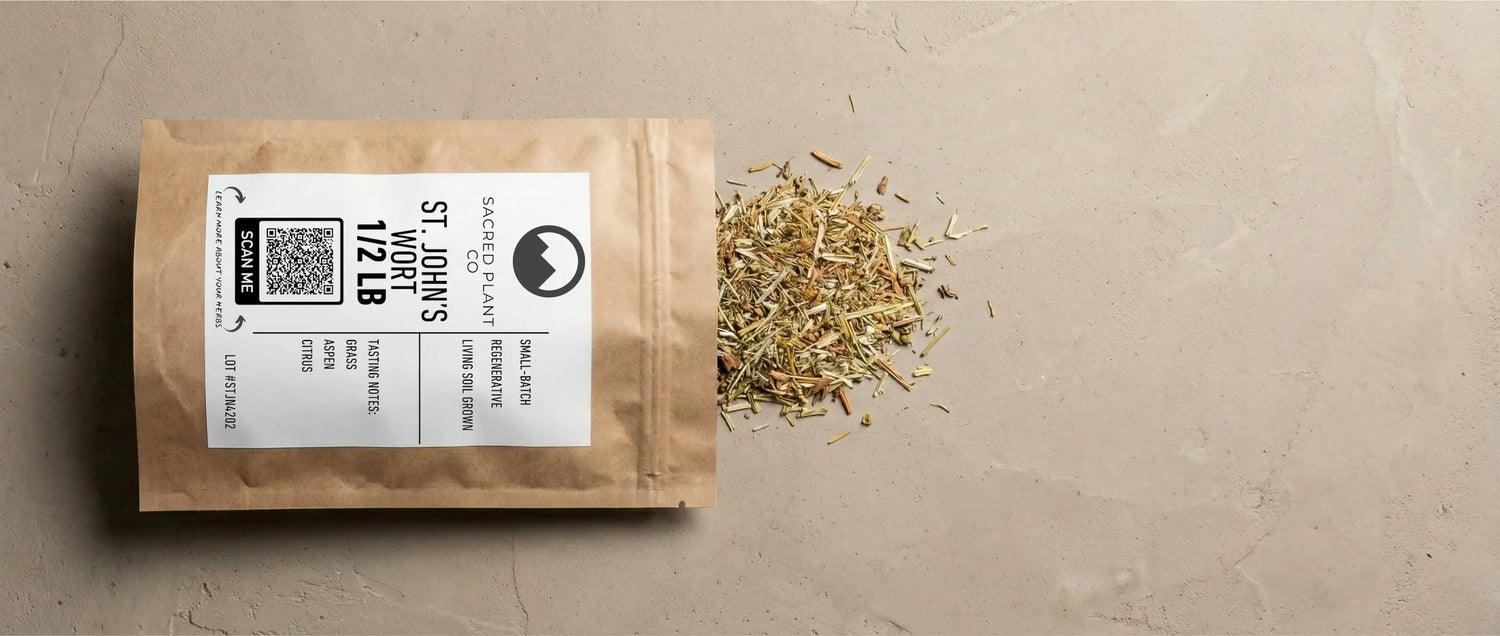 Dried, cut and sifted St. John's Wort herb spilling from a Sacred Plant Co pouch. The packaging features a scan-to-verify lot number and notes the herb is small-batch and grown in regenerative living soil to maximize therapeutic mood benefits.