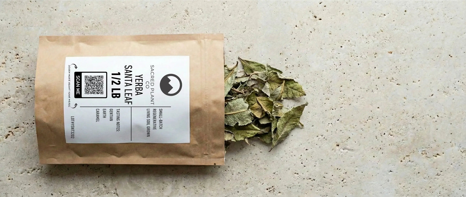 Dried Yerba Santa leaves spilling from a brown kraft paper pouch with a white label on a stone surface.