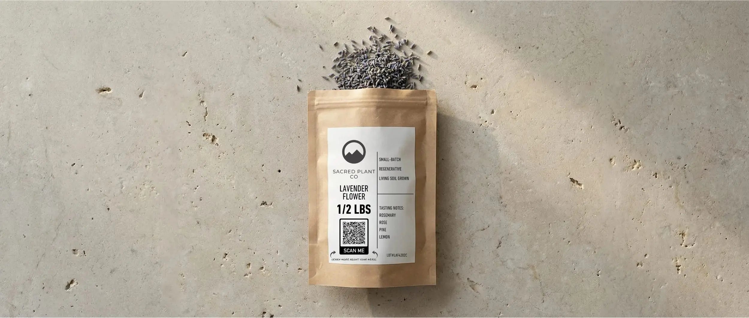Sacred Plant Co bulk Lavender Flower packaging on a stone surface, spilling out deep purple, high-altitude grown lavender buds.