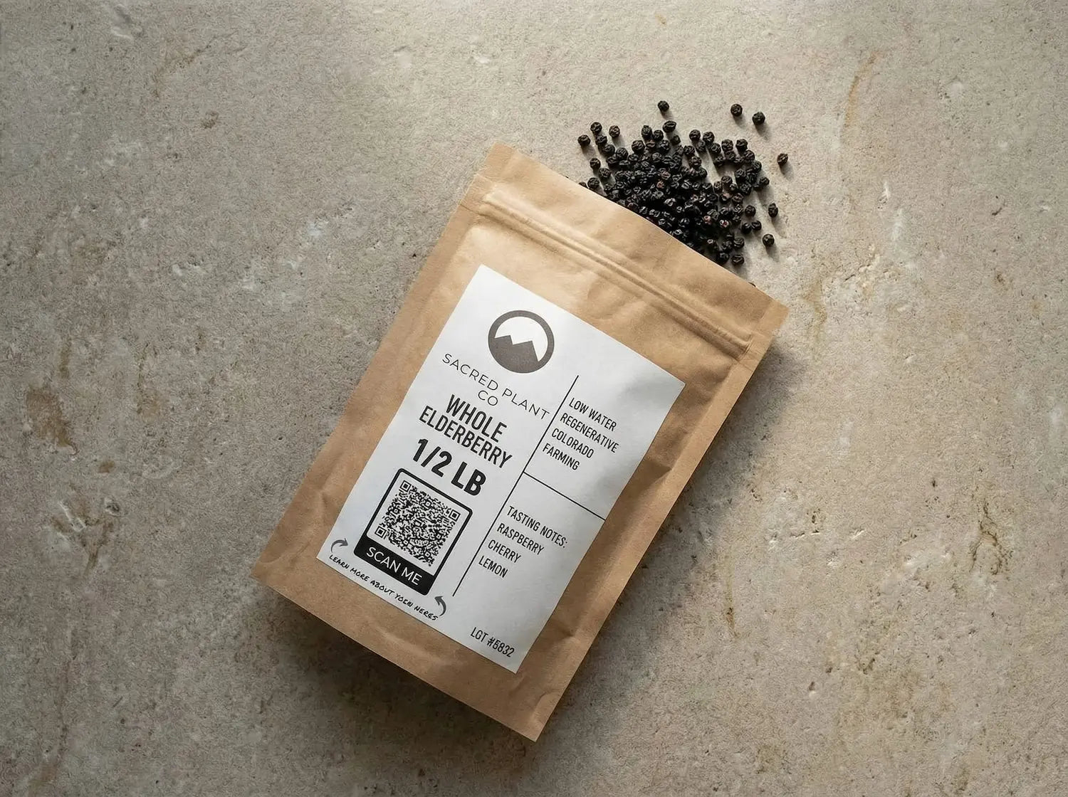 Sacred Plant Co dried whole elderberries spilling from a half-pound kraft pouch, illustrating natural herbal remedies for immune support and fighting seasonal illness.