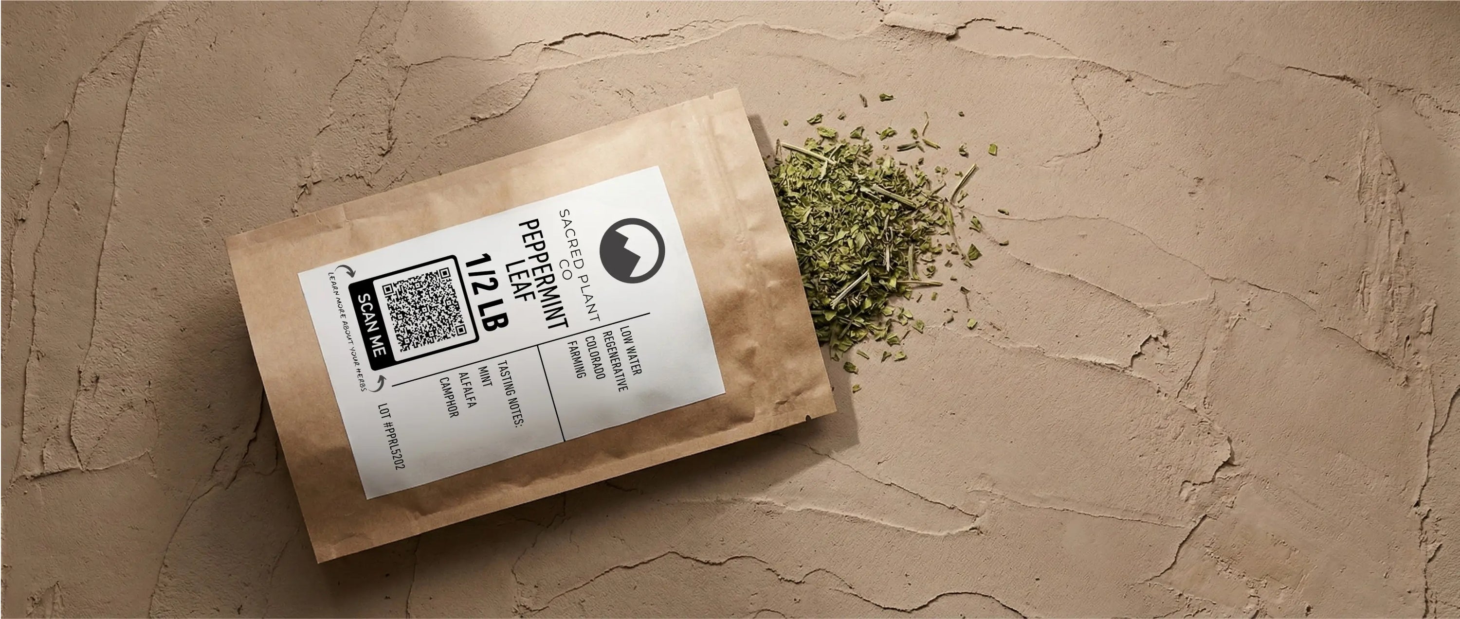 Bulk dried peppermint leaf in sustainable kraft packaging, featuring a scan-to-trace QR code for lot transparency.