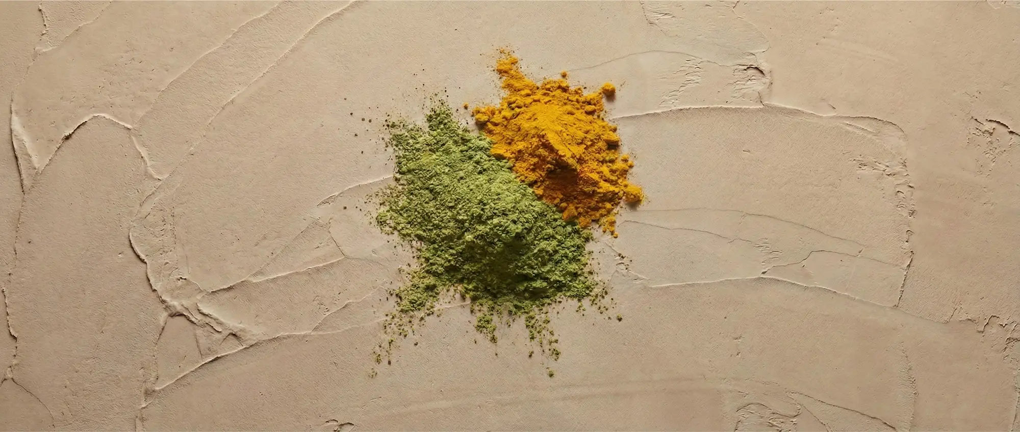 A close-up view of loose neem and turmeric powders, demonstrating the rich coloration that indicates high biological activity and proper drying methods.