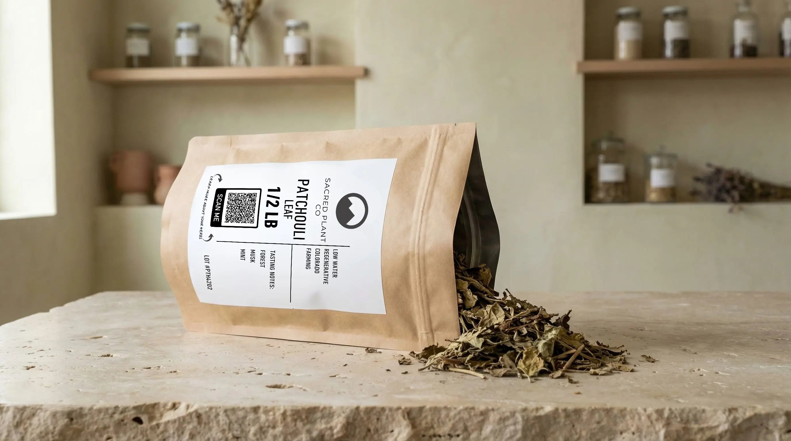 Sacred Plant Co patchouli leaf and stem in kraft bag with dried patchouli leaves displayed beside it