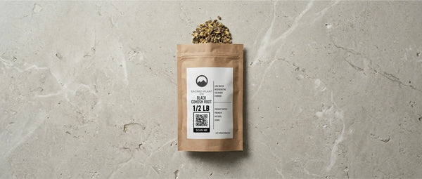 Sacred Plant Co premium dried black cohosh root in a 1/2 lb sealed kraft bag on a stone surface. The packaging features a scanable QR code and emphasizes regenerative farming practices essential for potent herbal medicine.