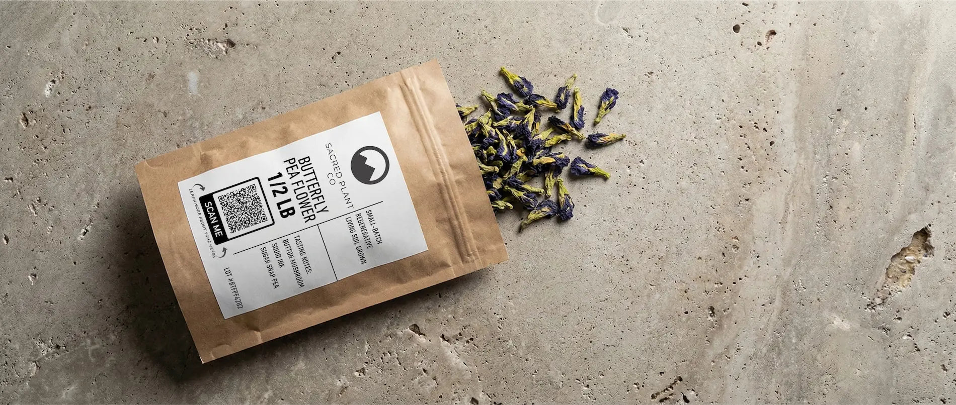 Sacred Plant Co half-pound bag of Butterfly Pea Flower featuring a label with tasting notes and a scanable QR code.