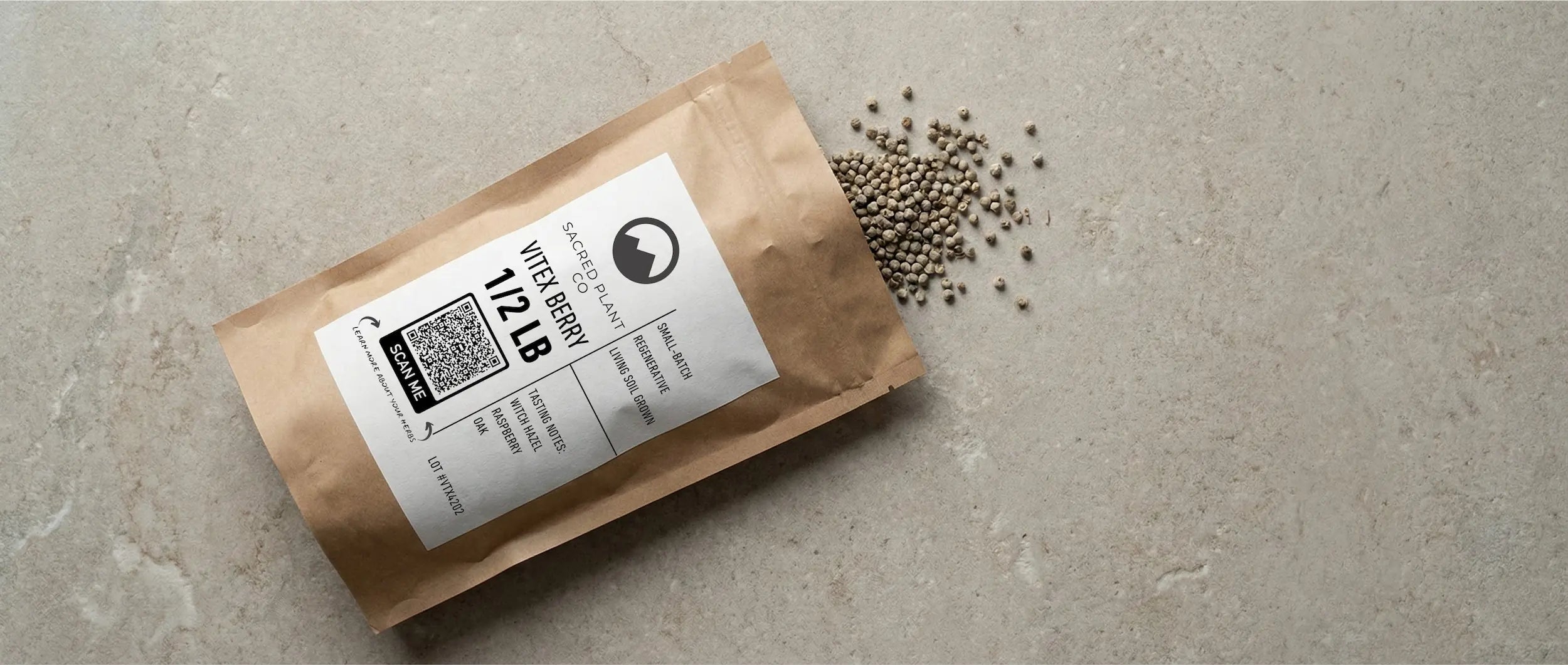 Sacred Plant Co premium whole vitex berries (Chaste Tree Berry) spilling from a craft paper bag, showing the high-quality, sustainably harvested texture of the herbs.