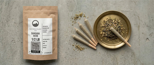 Regeneratively farmed half-pound damiana herb by Sacred Plant Co, displayed with loose smokable botanicals and hand-rolled herbal blends.