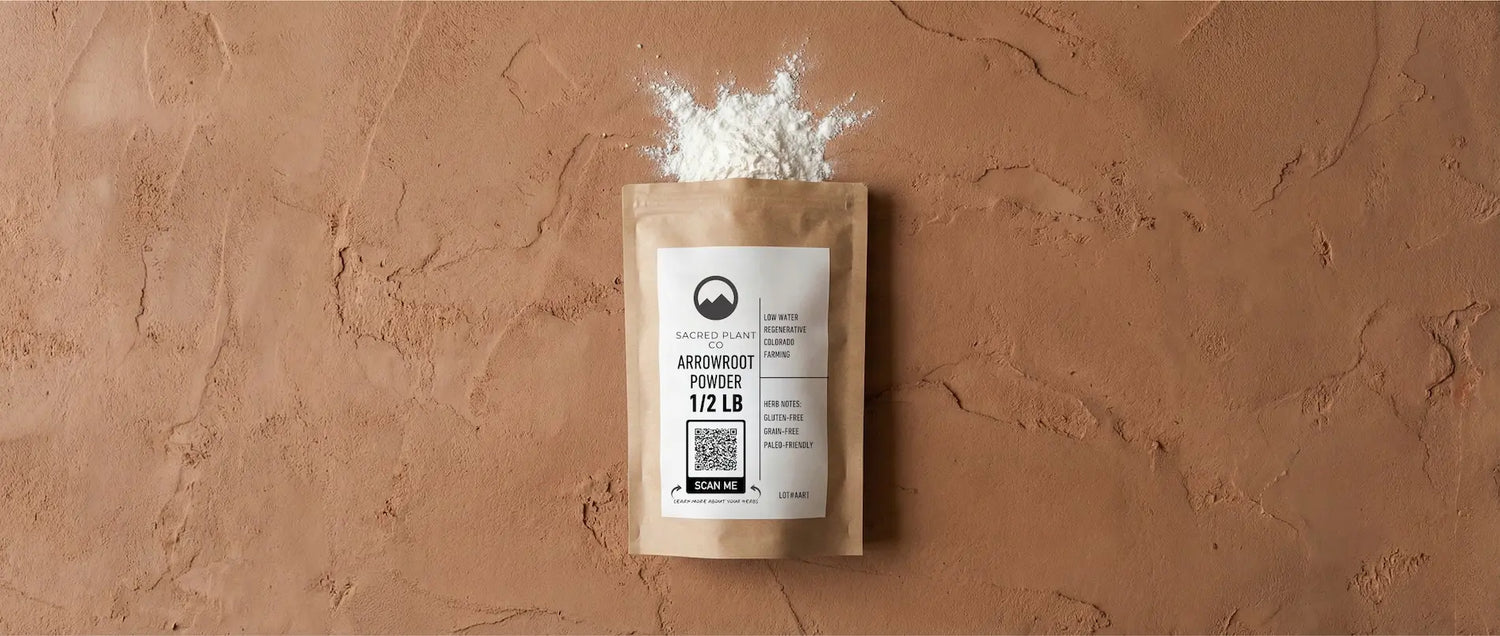 Product flat lay of Sacred Plant Co premium Maranta arundinacea arrowroot powder packaging showing fine white texture.