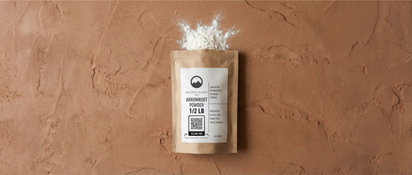 Product flat lay of Sacred Plant Co premium Maranta arundinacea arrowroot powder packaging showing fine white texture.
