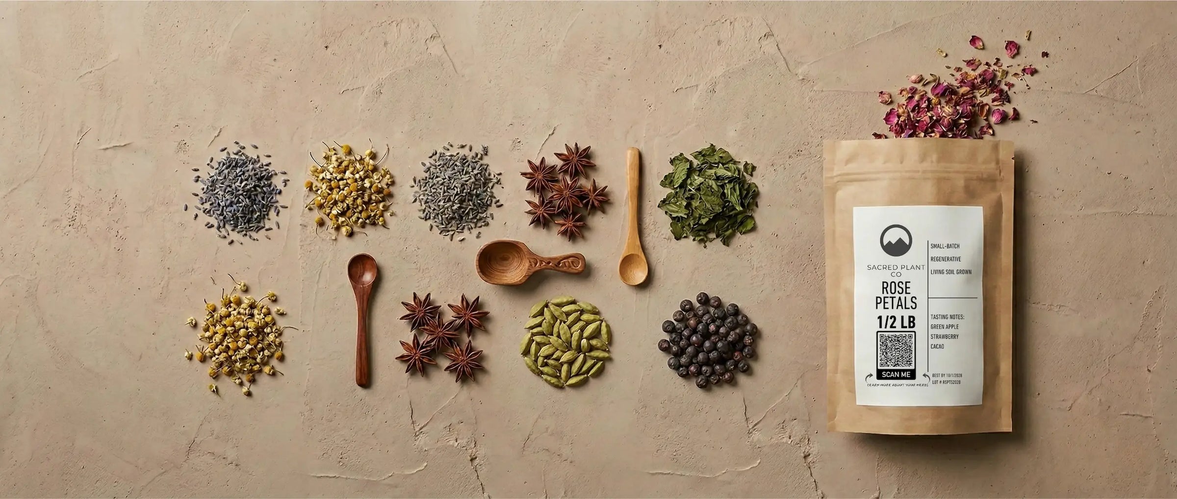 An assortment of organic dried herbs and botanicals displayed with wooden scoops and a brown kraft paper bag for wholesale bulk ordering.