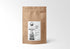 1 LB kraft paper bag of Bentonite Clay by Sacred Plant Co, perfect for detox, sourced through regenerative farming and known for its detoxifying properties.