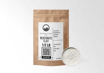 Sacred Plant Co Bentonite Clay in eco-friendly kraft paper packaging, sample in a silver tin, known for its detoxifying properties, often used in skincare routines to purify and cleanse the skin.