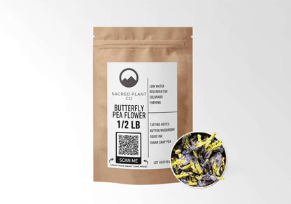 Sacred Plant Co Butterfly Pea Flower 1/2 LB in eco-friendly kraft paper packaging with a sample in a silver tin, traditionally used for enhancing cognitive function and creating natural blue dye in beverages and foods.