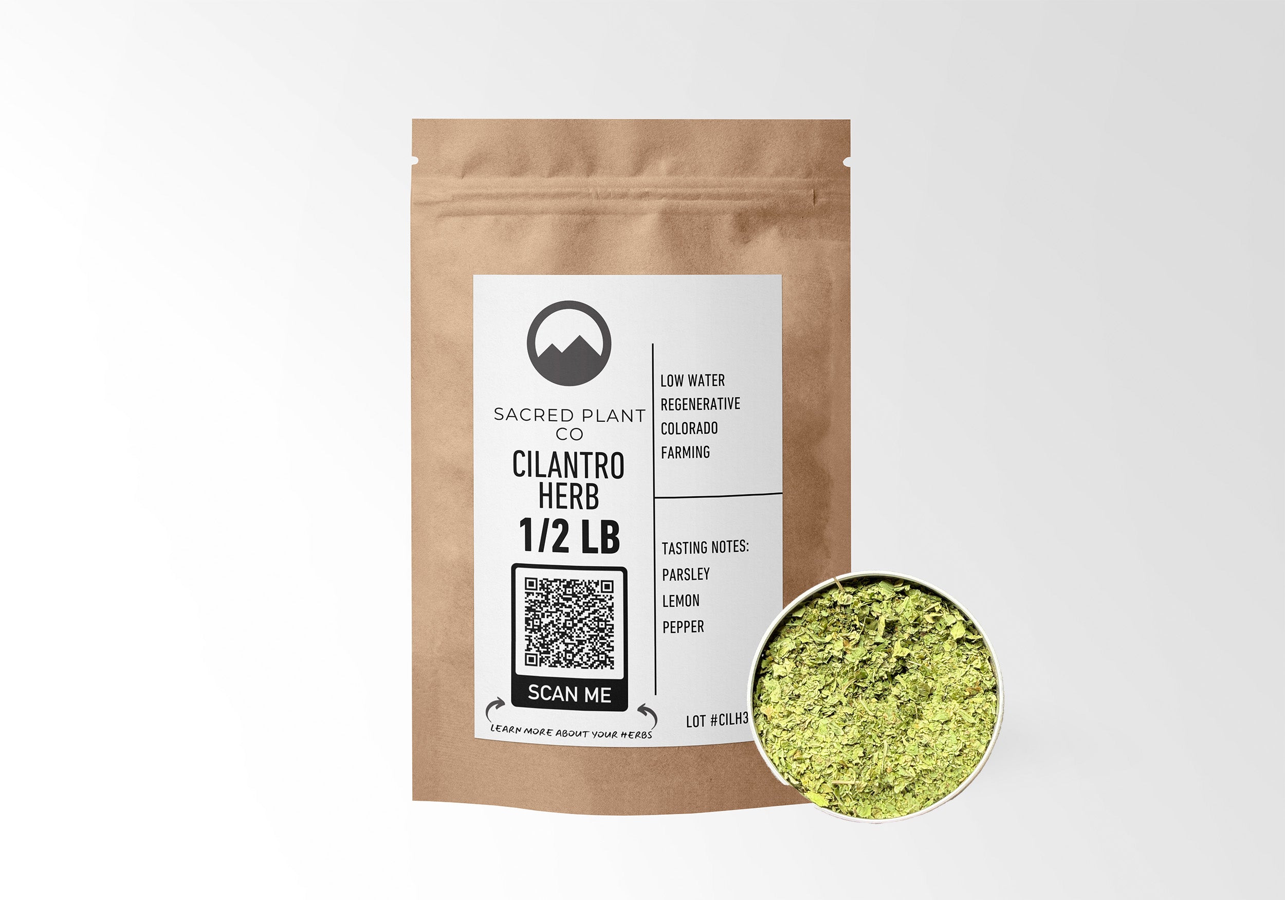 Sacred Plant Co Cilantro Herb 1/2 LB in eco-friendly kraft paper packaging with a sample in a silver tin, used for aiding digestion, supporting detoxification, and enhancing flavor in culinary dishes.