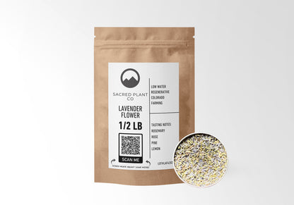 Sacred Plant Co Lavender Flower 1/2 LB in eco-friendly kraft paper packaging, with a sample of the herb in a silver tin, ideal for relaxation and stress relief.