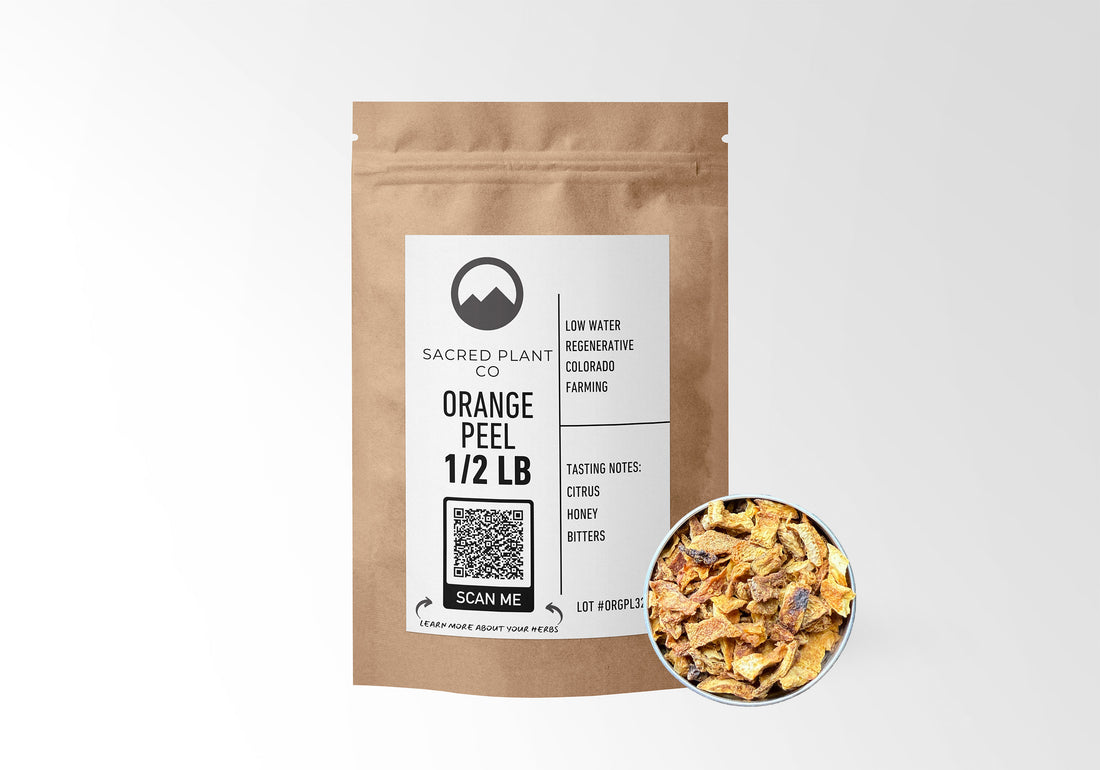 Sacred Plant Co Orange Peel 1/2 LB kraft paper packaging with sample in silver tin showcasing sustainably grown herb for usage in natural flavoring and wellness.