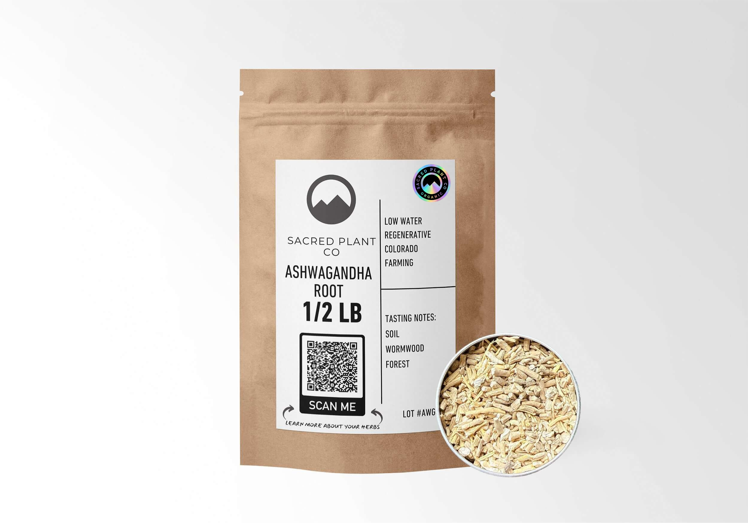 A 1/2 lb kraft pouch of Sacred Plant Co organic, cut Ashwagandha Root (Withania somnifera) displayed next to a sample of the chopped, dried pale root. The packaging label emphasizes low-water regenerative farming and lists earthy tasting notes of soil, wormwood, and forest.
