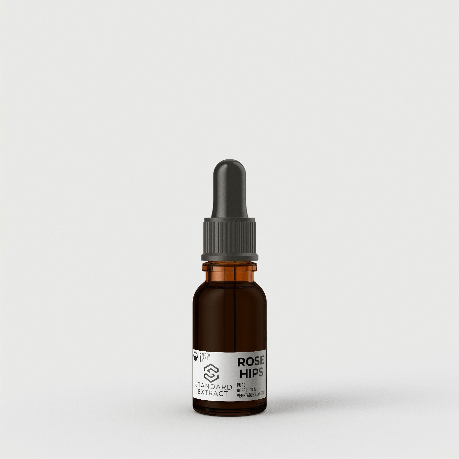 A close-up of a 15ml Sacred Plant Co Rose Hips Tincture in a dark amber bottle with a dropper, featuring the &