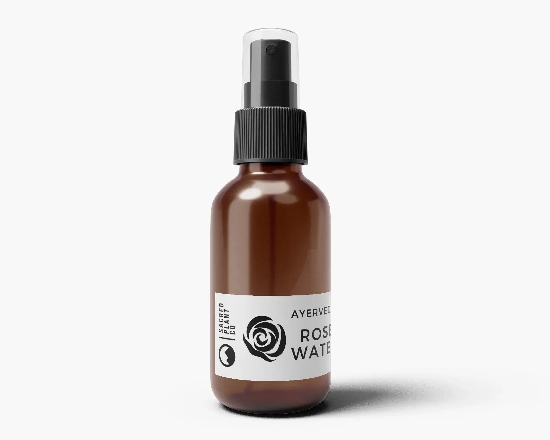 2 oz amber glass spray bottle of Sacred Plant Co Rose Water Hydrosol with minimalist white label, perfect for hydrating skin, toning, and mixing with clay masks.