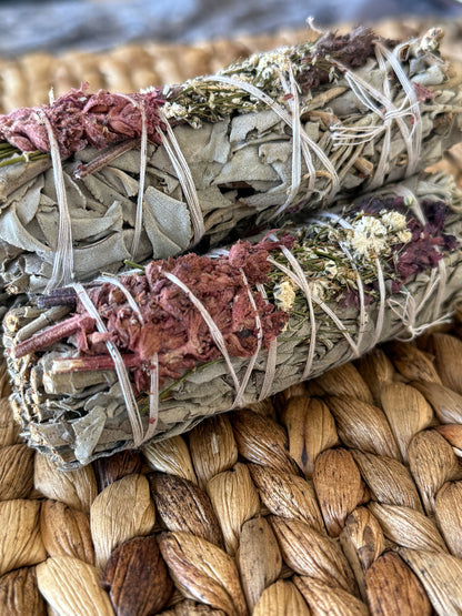 Artisan-crafted white sage smudge sticks with dried flowers, highlighting traditional purification practices and high-quality harvesting.