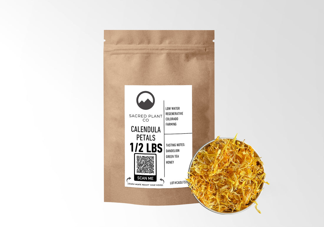 Beside a premium kraft paper pouch labeled Calendula Petals from Sacred Plant Co is a bowl full of bright yellow, high-grade calendula petals, accentuating the premium quality of the half-pound product.