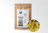 Sacred Plant Co Dried Dandelion Flowers 1/2 oz kraft pouch next to a bowl of whole dried dandelion blossoms.