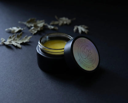 Flat lay of Moonmilk night balm botanicals: mugwort, California poppy, lemon balm, marshmallow, jojoba, beeswax and shea